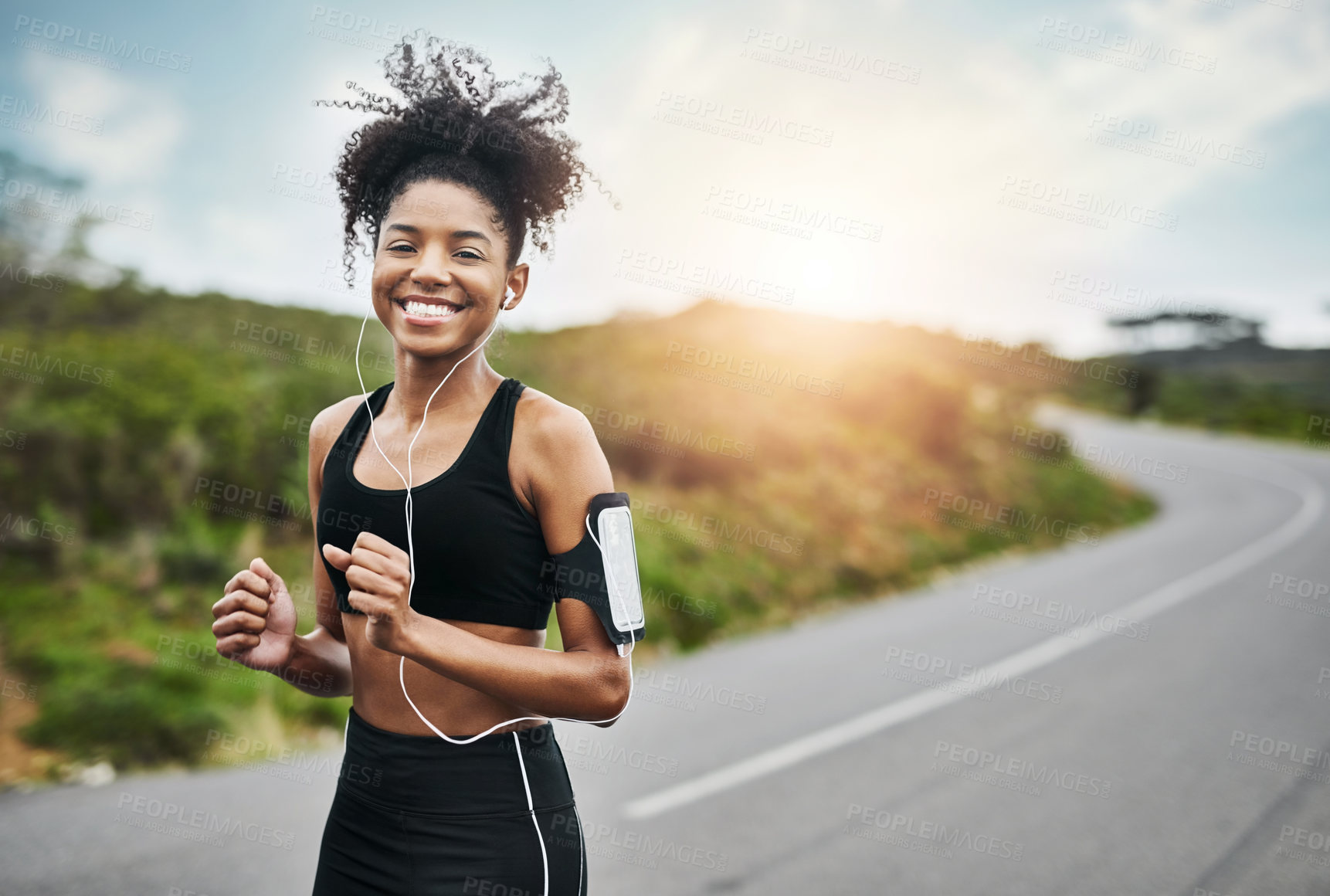 Buy stock photo Exercise, portrait and happy woman runner on a road with music for fitness, workout or cardio. Smile, sports and African female running in nature with podcast for training, motivation or performance