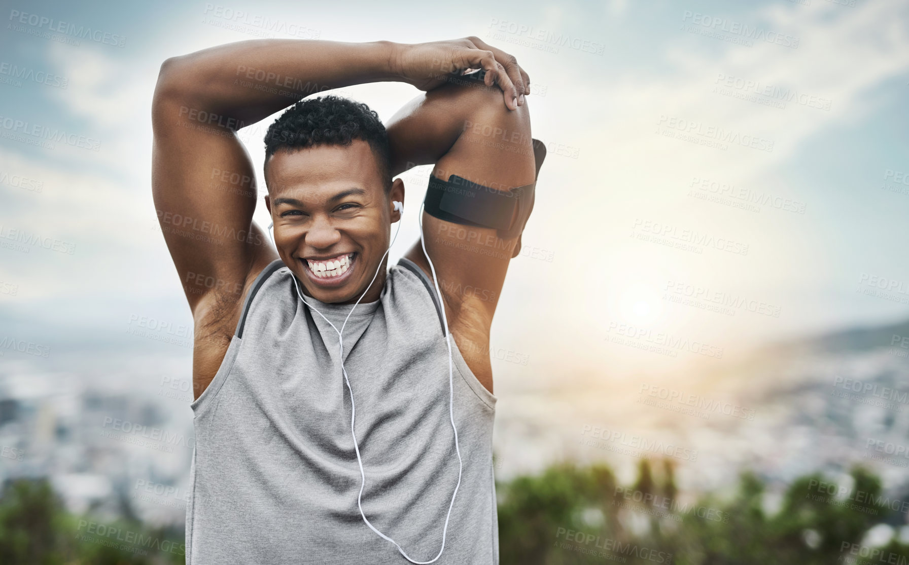 Buy stock photo Portrait, workout and black man stretching arms with smile, earphones and outdoor exercise in morning. Health, wellness and athlete at sunrise with warm up for muscle, fitness and happy face in city.