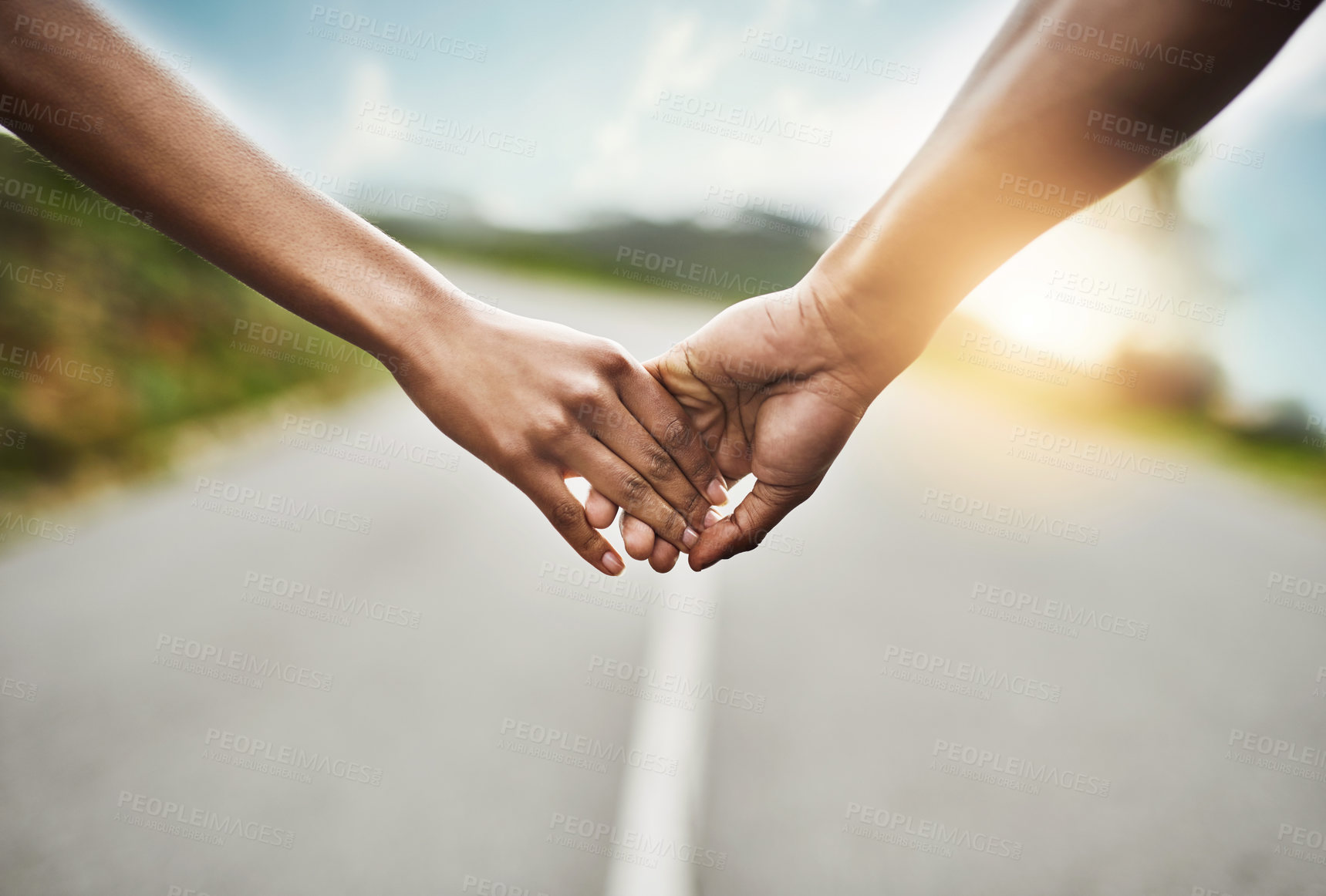 Buy stock photo Outdoor, couple and holding hands on road together, sunshine and adventure for healthy relationship. Connection, commitment and people with partner for summer journey, support and bonding for love