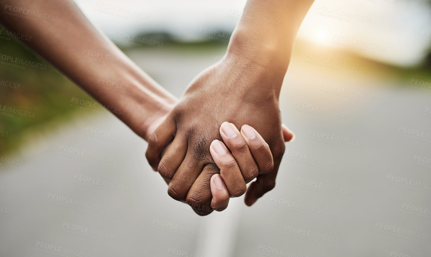 Buy stock photo Outdoor, people and holding hands on road together, sunshine and adventure for healthy relationship. Connection, commitment and couple with partner for summer journey, support and bonding for love