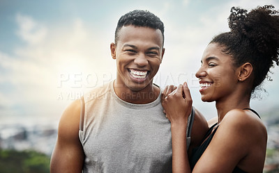 Buy stock photo Shot of a sporty young couple exercising together outdoors