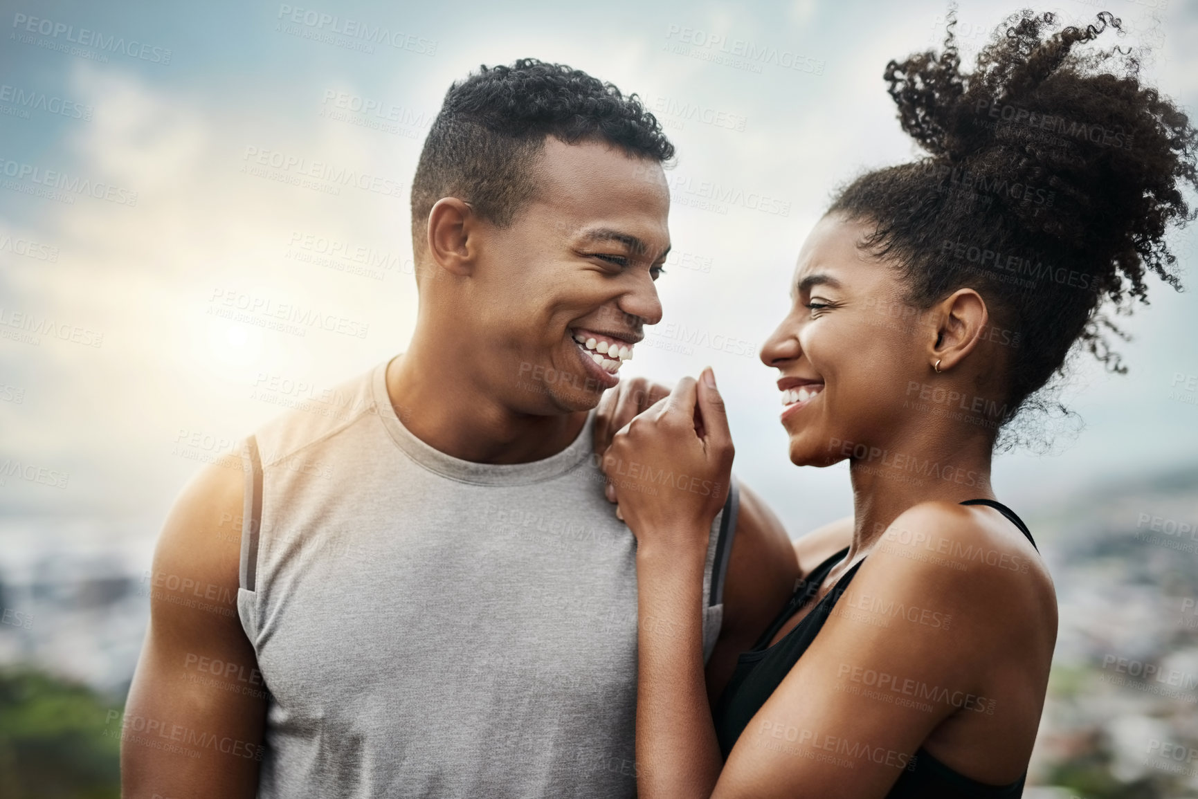 Buy stock photo Shot of a sporty young couple exercising together outdoors