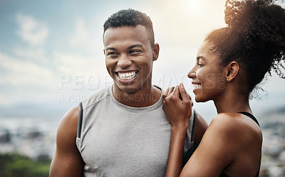 Buy stock photo Shot of a sporty young couple exercising together outdoors