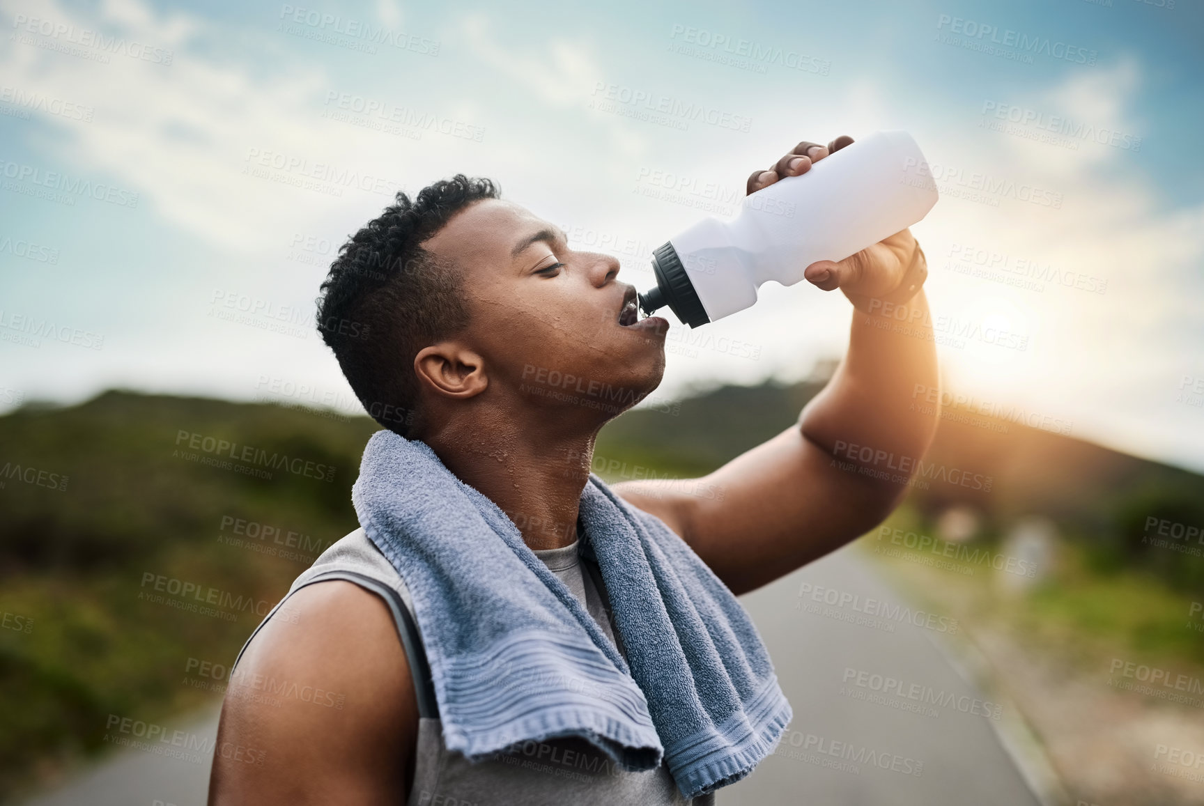 Buy stock photo Runner, nature and man drinking water for health, wellness or electrolytes on sports break. African person, fitness and bottle for hydration outdoor, tired and cool down after workout with sweat