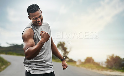 Buy stock photo Cropped shot of a handsome young sportsman cheering in celebration outside