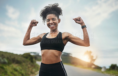 Buy stock photo Cropped portrait of an attractive young sportswoman flexing her biceps outside