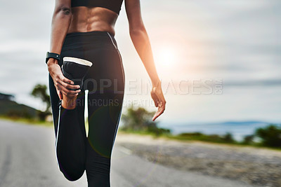 Buy stock photo Rearview shot of an unrecognizable young sportswoman warming up for a workout outdoors