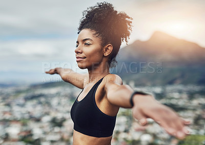Buy stock photo Cropped shot of an attractive young sportswoman warming up for a workout outdoors
