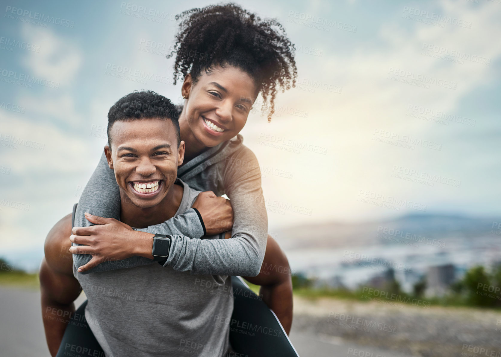 Buy stock photo Cropped portrait of a handsome young sportsman piggybacking his athletic young girlfriend outside