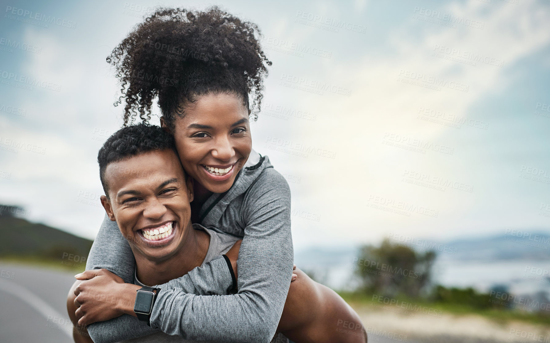 Buy stock photo Cropped portrait of a handsome young sportsman piggybacking his athletic young girlfriend outside