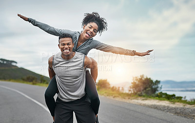 Buy stock photo Cropped portrait of a handsome young sportsman piggybacking his athletic young girlfriend outside