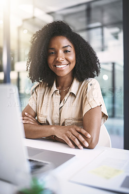 Buy stock photo Portrait of a young businesswoman using a laptop at her desk in a modern office