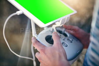 Buy stock photo Closeup of a man holding a remote control to fly a drone on a beach outside during the day