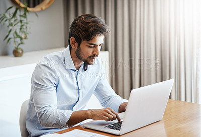 Buy stock photo Serious man, remote work and typing on laptop in home at table for digital planning, research and online network. Focused male freelancer working on computer keyboard, internet technology and website