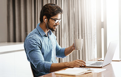 Buy stock photo Cropped shot of a handsome young businessman working on his laptop in the office at home