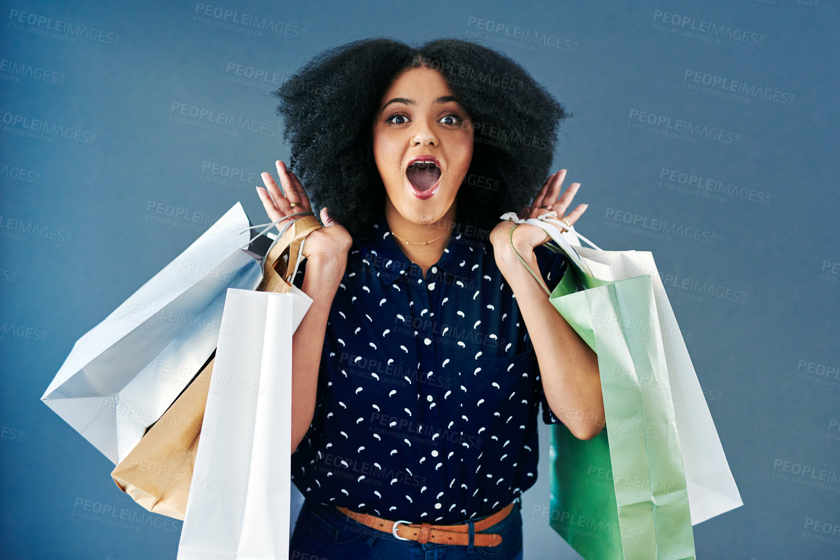 Buy stock photo Happy woman, portrait and shock with shopping bags for deal, announcement or promotion on a studio background. Young female person, shopper or customer in surprise, wow or OMG for purchase or buying