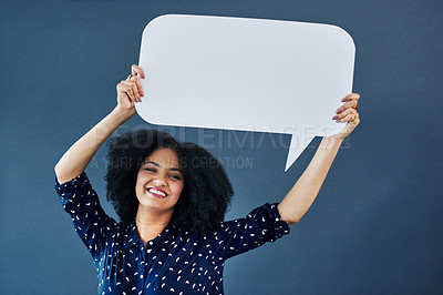 Buy stock photo Portrait, speech bubble and woman in studio with banner, news or announcement on blue background. Mockup, poster and happy female face with billboard for social media, advertising or branding launch