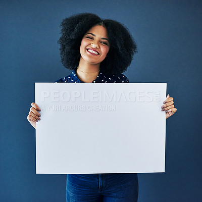 Buy stock photo News, mockup and portrait of a woman with a poster isolated on a blue background in studio. Smile, showing and young corporate copywriter with a blank board for branding, design and information space
