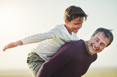 Buy stock photo Shot of a father and son having fun together outdoors