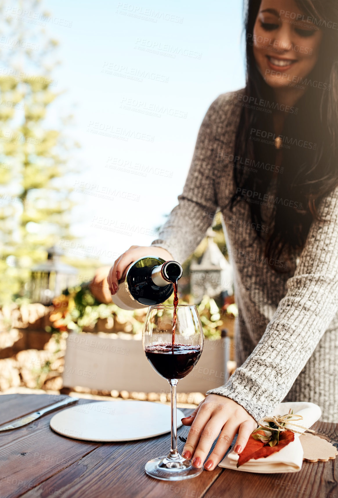 Buy stock photo Woman, pour or glass with wine at thanksgiving dinner for celebration, preparation or holiday in backyard, Bottle, champagne or serve alcohol in home for part tradition, beverage or drinks to relax