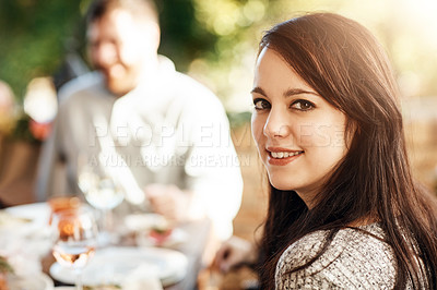 Buy stock photo Cropped portrait of an attractive young woman sitting around the Thanksgiving table with her family