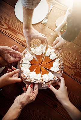 Buy stock photo Cropped shot of a group of unrecognizable people each taking a slice of pumpkin pie on Thanksgiving