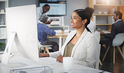 Buy stock photo Shot of a young businesswoman using a computer at her work desk