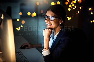Buy stock photo Shot of a young businesswoman working late on a computer in an office