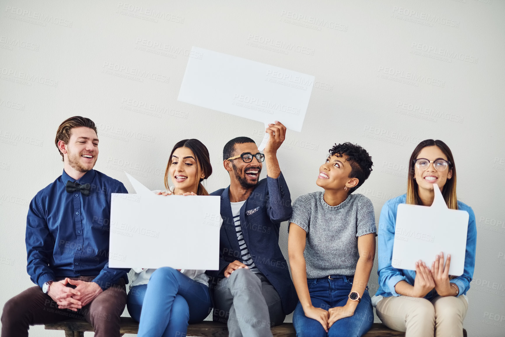 Buy stock photo Shot of a diverse group of creative employees holding up speech bubbles inside