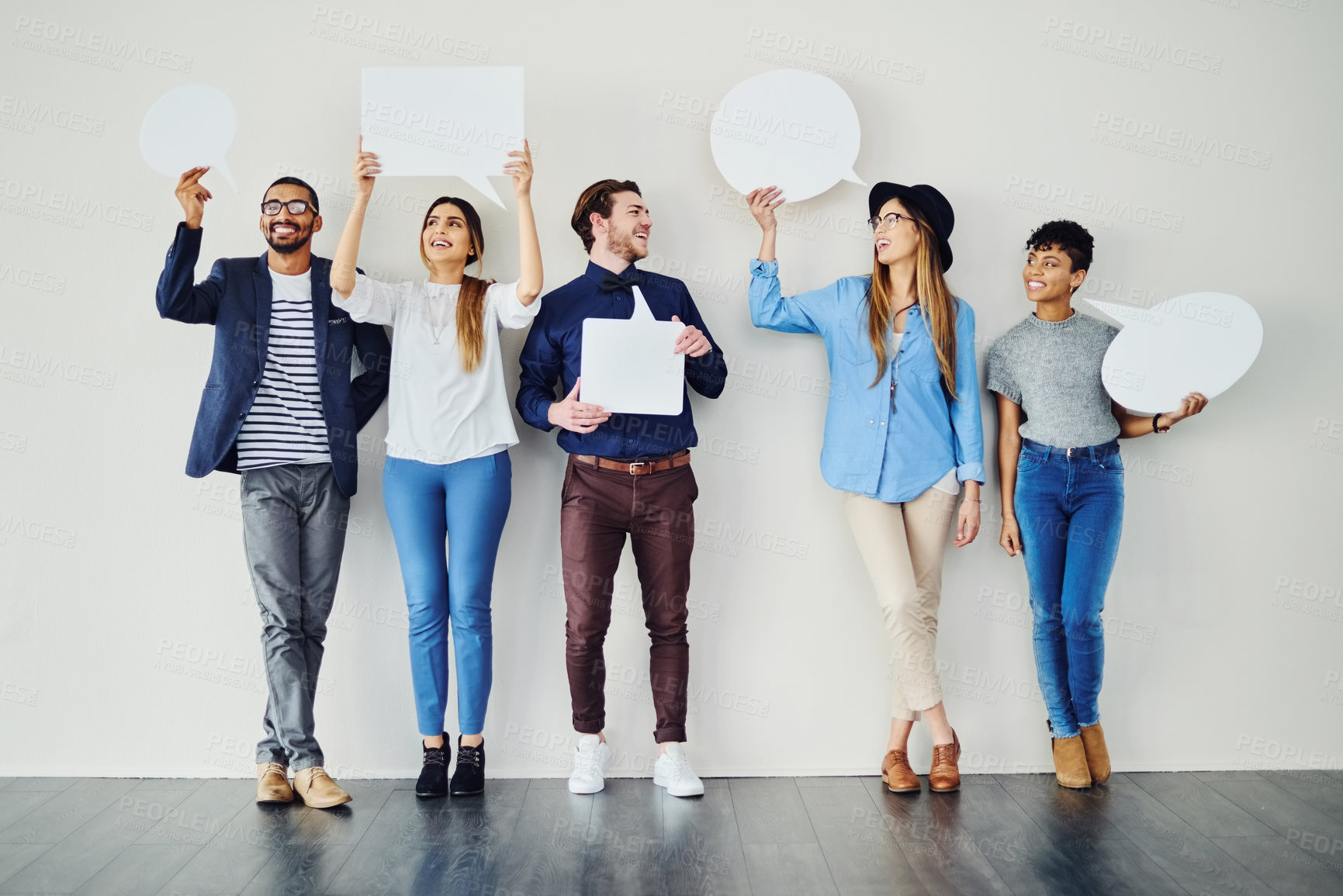 Buy stock photo Shot of a diverse group of creative employees holding up speech bubbles inside