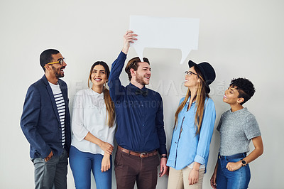 Buy stock photo Shot of a diverse group of creative employees holding up a speech bubble inside