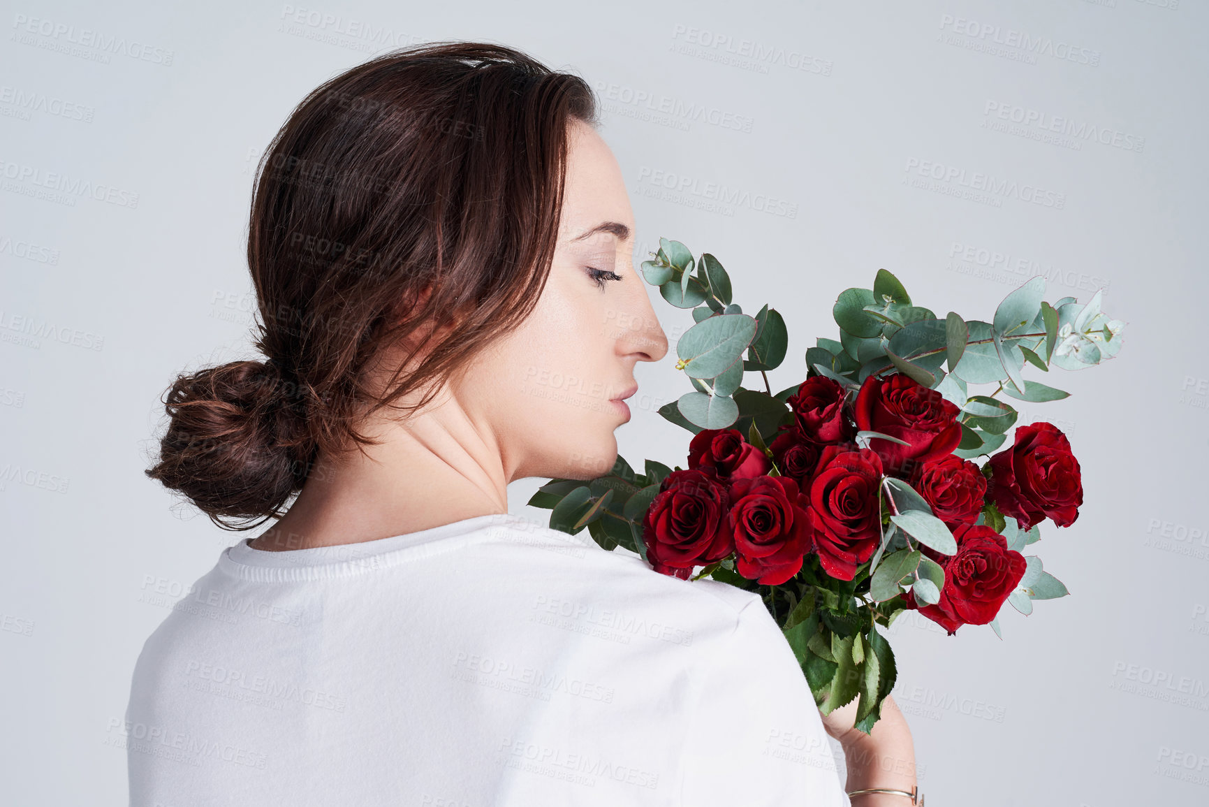 Buy stock photo Woman, profile and valentines day with red roses or flower bouquet for anniversary or gift on a white studio background. Young female person or model with natural plant or leaves for romance or love