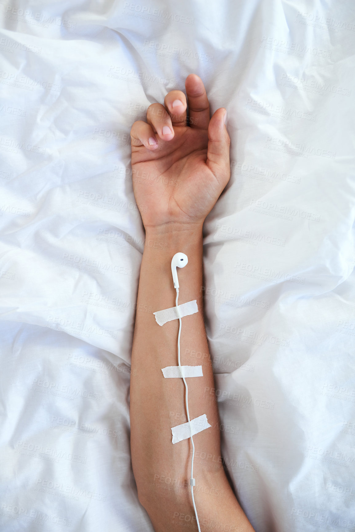 Buy stock photo Arm, person and earphones with tape for audio to heal mind, soul and body on break and relax. Bed, track and streaming service for self care with melody or rhythm with motivational music and sound