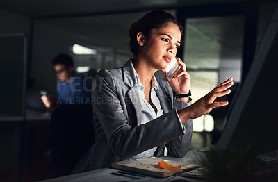 Buy stock photo Cropped shot of a young attractive businesswoman working late at night in the office