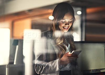 Buy stock photo Cropped shot of a young attractive businesswoman using a tablet while working late at night in the office