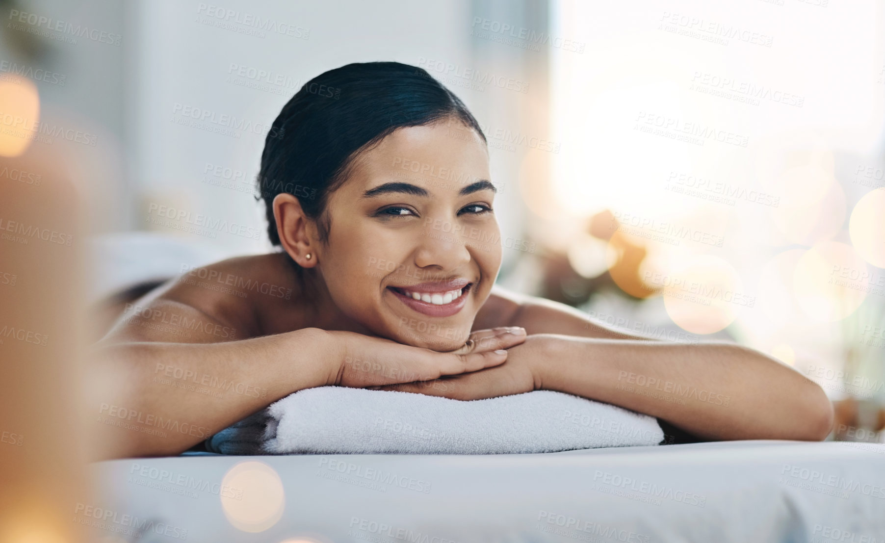 Buy stock photo Portrait, spa and woman with massage, relax and enjoy wellness with beauty treatment, vacation and weekend break. Face, happy person and girl on bed, holistic and peaceful with smile and calm