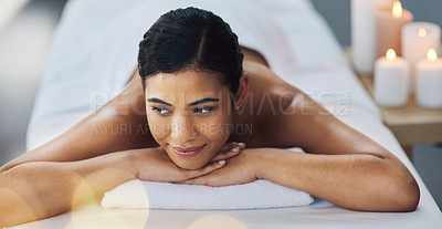 Buy stock photo Shot of a relaxed an cheerful young woman getting a massage indoors at a spa