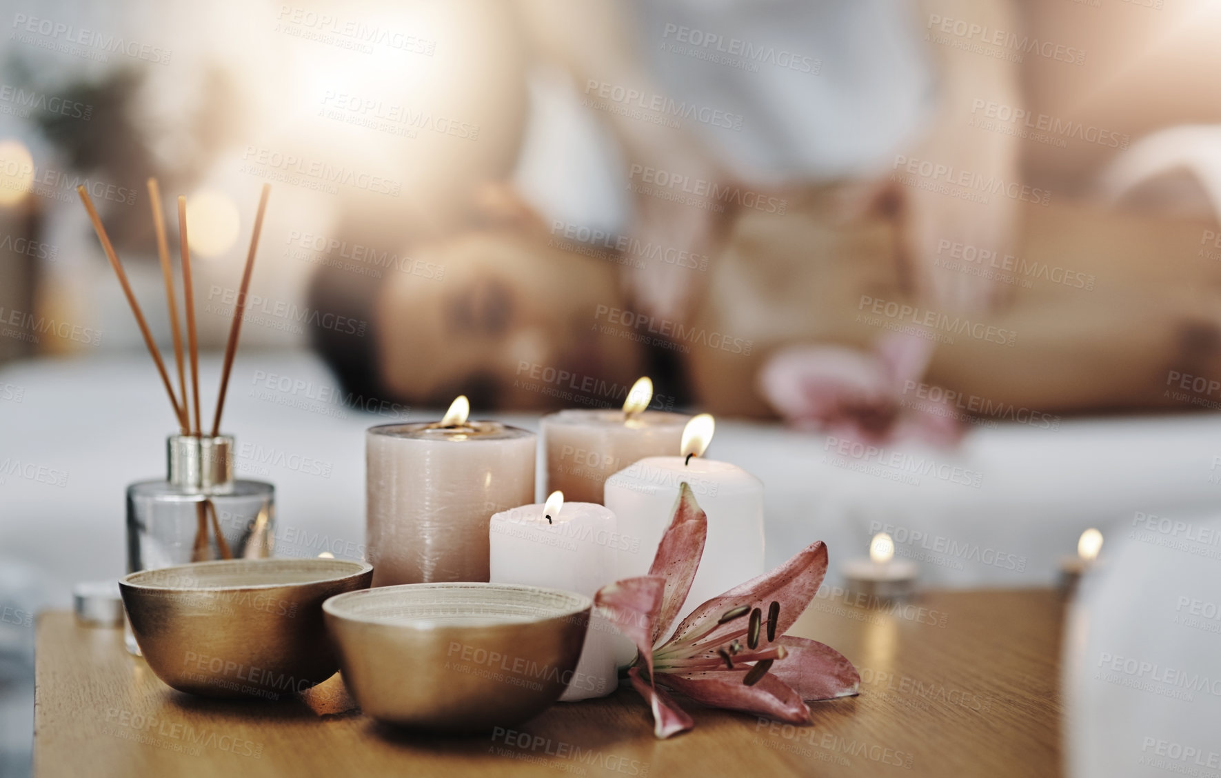 Buy stock photo Shot of a relaxed an cheerful young woman getting a massage indoors at a spa