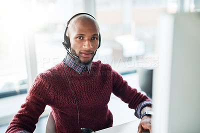 Buy stock photo Cropped portrait of a handsome young male call center agent working in his office