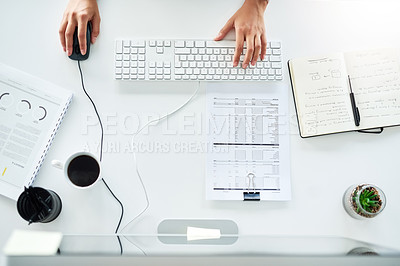 Buy stock photo High angle shot of an unrecognizable young businesswoman working at her desk in the office