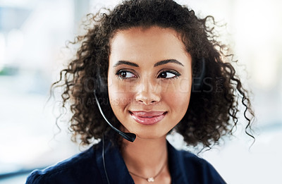 Buy stock photo Cropped shot of an attractive young female call center agent looking thoughtful while working in her office