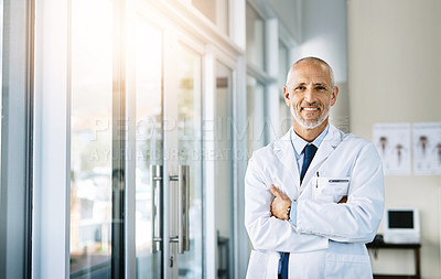 Buy stock photo Mature doctor, smile and portrait with arms crossed in hospital feeling proud from medical work. Healthcare, wellness and professional employee with happiness from health support and physician job