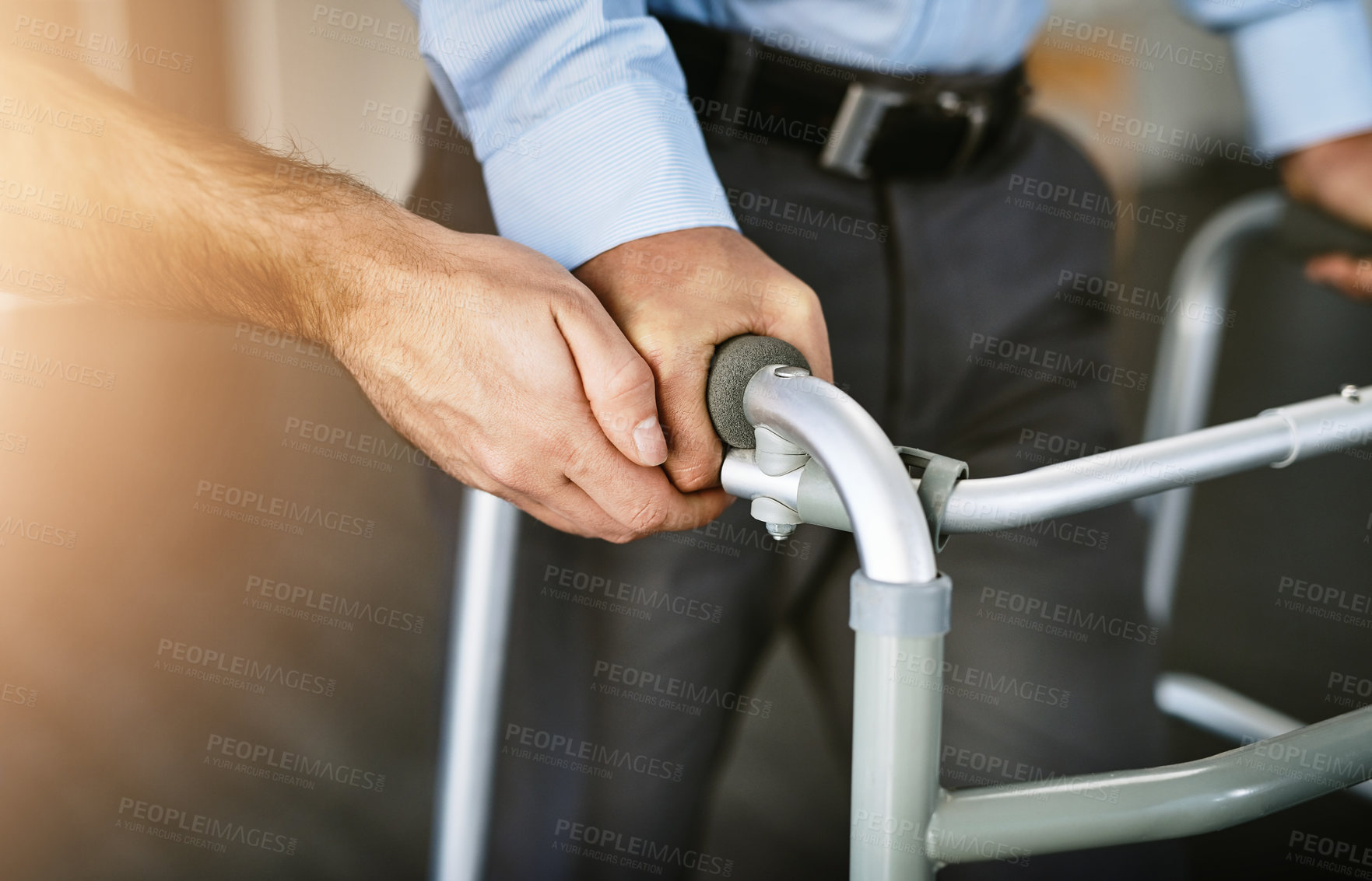 Buy stock photo Hands, walker and help for person with disability in nursing home, physiotherapy with empathy for arthritis. People, together and therapist with support for Parkinson in clinic, moving for healing