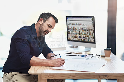 Buy stock photo Shot of a mature male architect working in his office