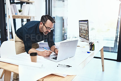 Buy stock photo Shot of a mature male architect working on his laptop