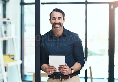 Buy stock photo Cropped shot of a mature businessman working on his tablet in the office
