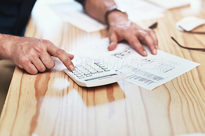 Buy stock photo Cropped shot of an unrecognizable man calculating information on a document