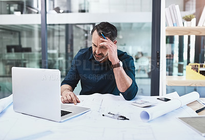 Buy stock photo Shot of a mature male architect using his laptop