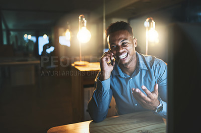 Buy stock photo Cropped shot of a handsome young businessman making a phonecall while working late at night in a modern office