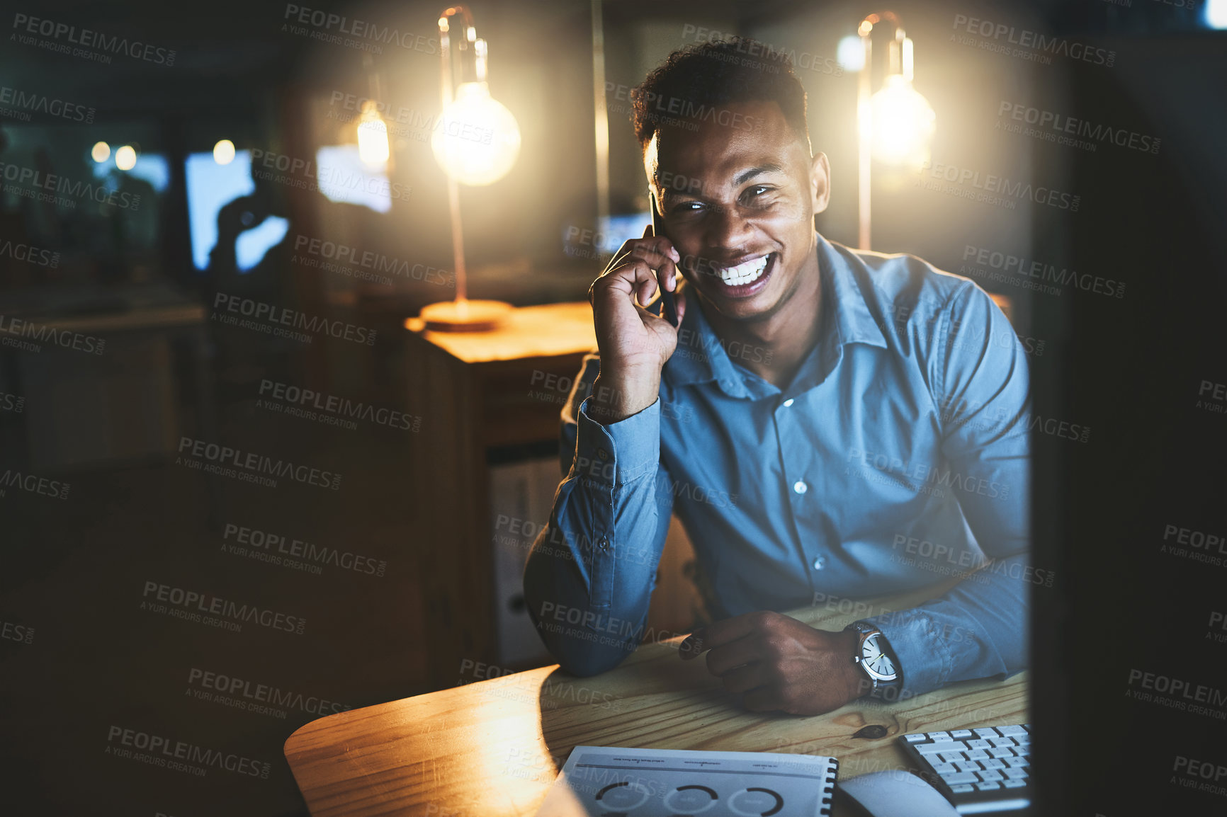 Buy stock photo Night, happy and black man at desk with phone call, web and lead generation at tech startup. Dark, smile and businessman with smartphone, networking contact and business connection at digital agency.